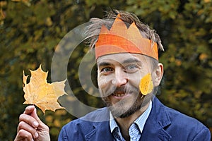 King of the fall. Funny bearded man in paper crown with yellow l