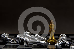 The king golden chess standing in the middle of the falling silver chess.Concepts of leadership and business strategy