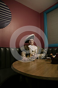 King Henry VIII relaxing after meal in cafe photo