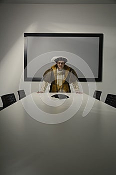 King Henry VIII standing in conference room