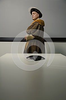 King Henry VIII standing in conference room