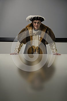 King Henry VIII standing in conference room