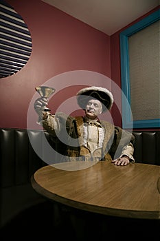 King Henry VIII toasting with goblet in bar photo