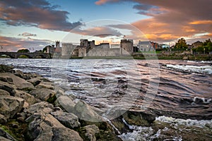 The King John Castle over the Shannon river in Limerick at sunset, Ireland