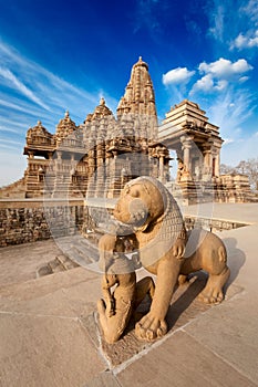 King and lion fight statue and Kandariya temple photo