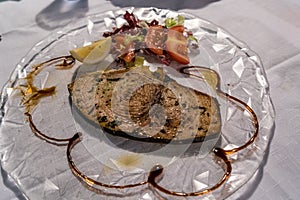 King mackerel steak with salad and tomato on the table