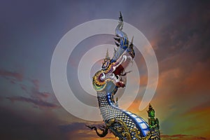 King of Nagas, Great Naga on sunset sky, sculpture found in the Buddhism temples, Wat Rong Sua Ten, Chiang Rai, Thailand