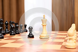 King and pawn pieces among others on chessboard indoors