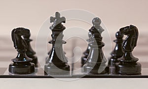 King and queen in chess with pawn army isolated on a white background. Macro photography