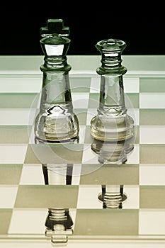 King and queen glass chess piece facing each other in green and yellow shade