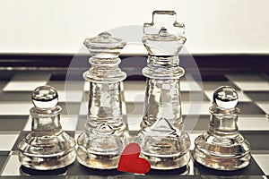 King, queen and pawns on chess board
