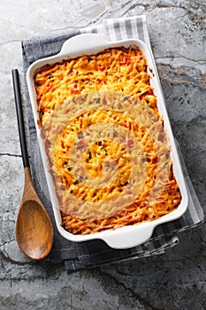 King Ranch Chicken Casserole with pulled chicken, corn tortillas, shredded cheese, peppers, and spicy green chiles close-up in a