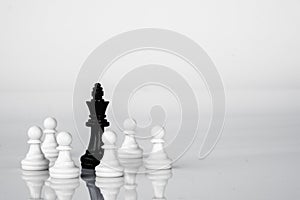 King is in trouble, surrounded by the enemies. Business strategy and competition concept. Black and White