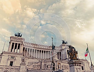 King Vittorio Emanuele monument's impressive facade under cloudy sky.