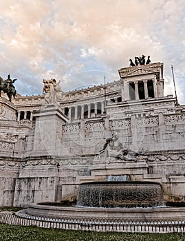 King Vittorio Emanuele monument's impressive facade under cloudy sky.