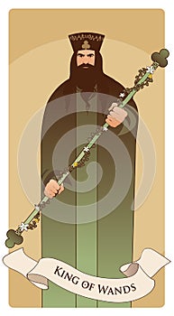 King of Wands with crown and symbolic trefoil, holding a rod surrounded by a garland of leaves and flowers.