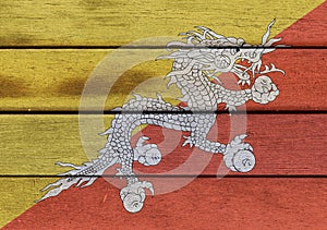 Kingdom of Bhutan flag on wooden surface