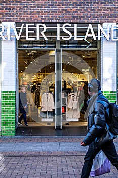 People Walking Past A Branch Of A River Island Fashion Shop