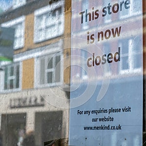 Shop Window Business Closed Sign In A Shop Or Store  With A Reflection Of A High Street