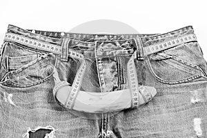 Kinky fruit on jeans crotch, close up. Jeans with banana on crotch on white background