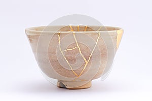 Kintsugi antique Japanese bowl restored with gold. photo