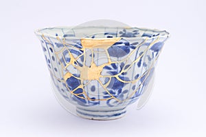 Kintsugi antique Japanese bowl restored with gold. photo