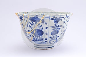 Kintsugi antique Japanese bowl restored with gold. photo