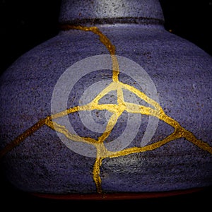 A kintsugi repaired vase with gold.