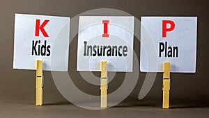 KIP kids insurance plan symbol. Concept words KIP kids insurance plan on beautiful white paper. Beautiful grey background. photo