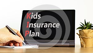 KIP kids insurance plan symbol. Concept words KIP kids insurance plan on beautiful black tablet. Beautiful white background.