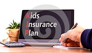 KIP kids insurance plan symbol. Concept words KIP kids insurance plan on beautiful black tablet. Beautiful white background.