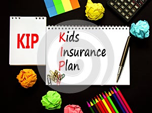 KIP kids insurance plan symbol. Concept words KIP kids insurance plan on beautiful white note. Beautiful black background. Black photo