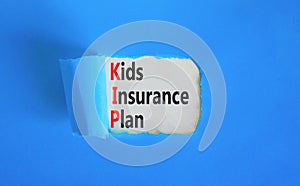 KIP kids insurance plan symbol. Concept words KIP kids insurance plan on beautiful white paper. Beautiful blue paper background.