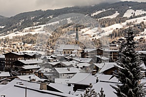 Kirchberg in Tirol, Tirol/Austria - March 26 2019: Church and houses in the village covered with a tin layer of snow