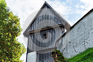 Kirchberg in Tirol, Tirol/Austria - September 18 2018: Wooden and stone building behind the church shot from a low angle