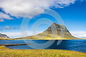 Kirkjufell, kirkjufellsfoss and atlantic ocean iceland in summer august