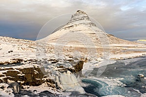 Kirkjufell Mountain in the Snaefellsnes Peninsula at winter. Waterfall and landscape in Iceland