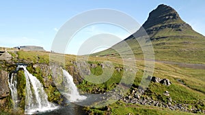 Kirkjufell mountain and waterfall in the snaefellsnes peninsula, during summer