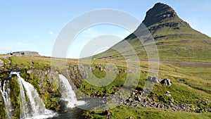 Kirkjufell mountain and waterfall in the snaefellsnes peninsula, during summer