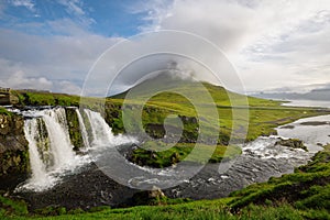 Kirkjufellfoss and Kirkjufell mountain in cloudy day ,Iceland