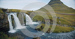 Kirkjufellsfoss flowing water and Kirkjufell in northern Iceland