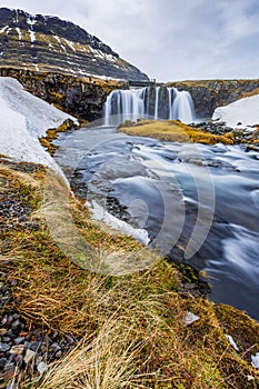 Kirkjufellsfoss, Kirkjufell waterfall roars with water from recent rain in Winter