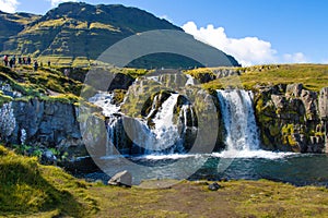 Kirkjufellsfoss meeting the north atlantic ocean iceland in summer august