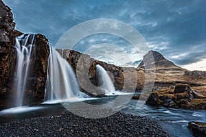 Kirkjufellsfoss waterfalls and kirkjufell mountain in the morni