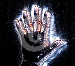 Kirlian aura photography of a glowing human female hand showing different symbols and show of hands