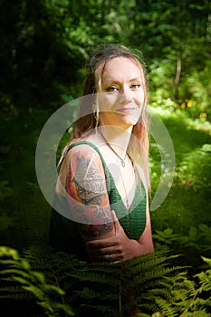 Kirov, Russia - June 29, 2022: Portrait of girl with Tattoo looking as peautiful seductive dryad. Pagan spirit of the