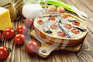 Kish with sprats and cherry tomatoes