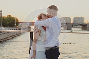 A kiss of the bride and groom at sunset. Wedding article. A happy couple. Love. Photos for printed products.