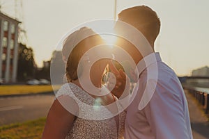 A kiss of the bride and groom at sunset. Wedding article. A happy couple. Love. Photos for printed products.