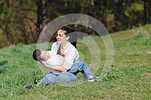 Kiss and hugs of mom and son. Mom and son walk in the summer park. Family holiday and togetherness. Happy mother`s day